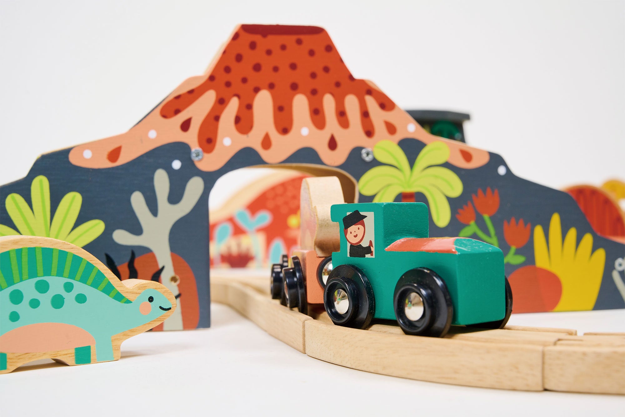mentari wooden train set dinosaur train set volcano with locomotive coming through close-up